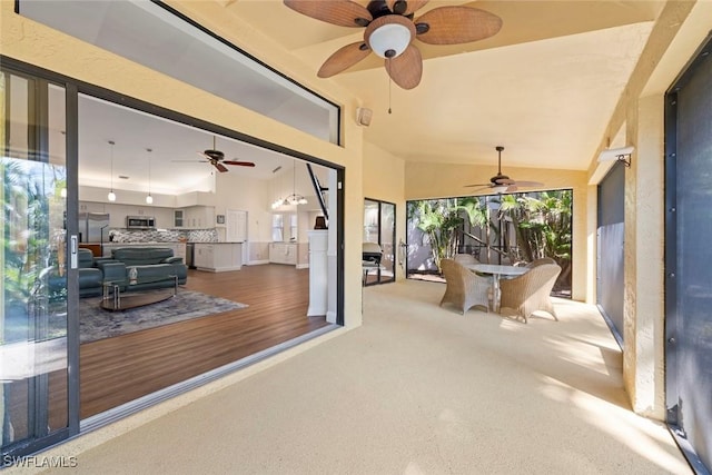 sunroom / solarium featuring vaulted ceiling and a wealth of natural light