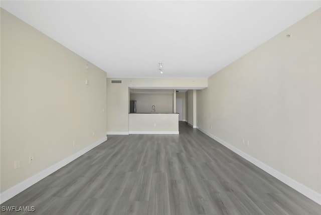 unfurnished living room featuring dark hardwood / wood-style floors