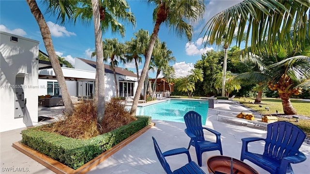 view of swimming pool featuring a patio area