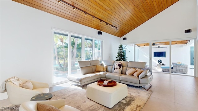 tiled living room with high vaulted ceiling, wooden ceiling, and rail lighting