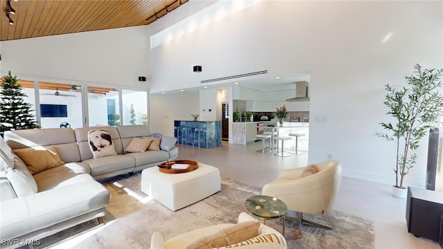 living room featuring high vaulted ceiling and wooden ceiling