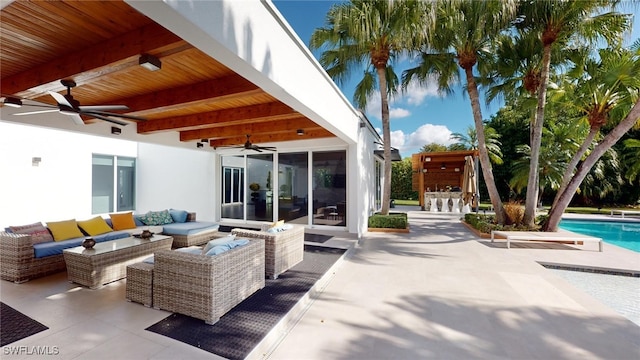 view of patio featuring ceiling fan, exterior bar, and an outdoor hangout area