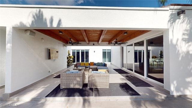 back of house with ceiling fan and an outdoor living space