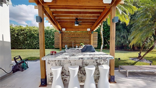 view of patio / terrace with an outdoor bar and ceiling fan