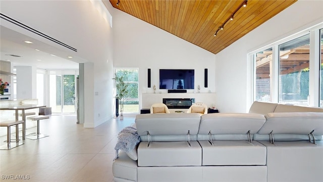 living room featuring high vaulted ceiling, track lighting, and wood ceiling