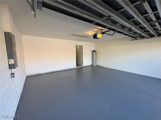 garage featuring a garage door opener, electric panel, and water heater