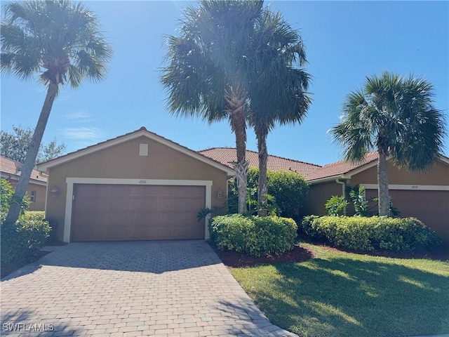 single story home featuring a garage and a front yard