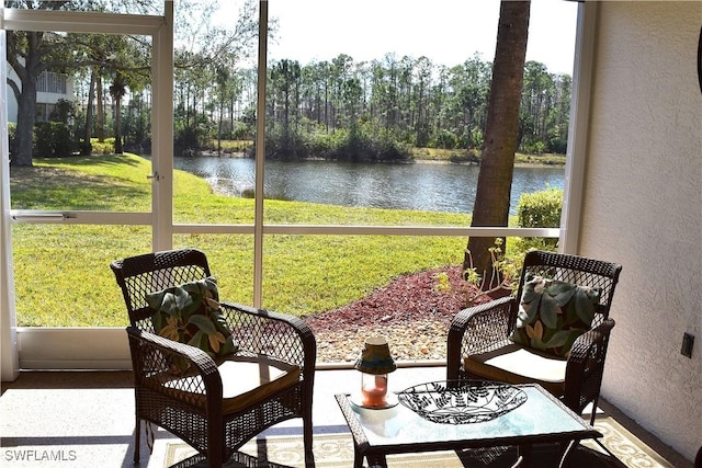 sunroom featuring a healthy amount of sunlight and a water view