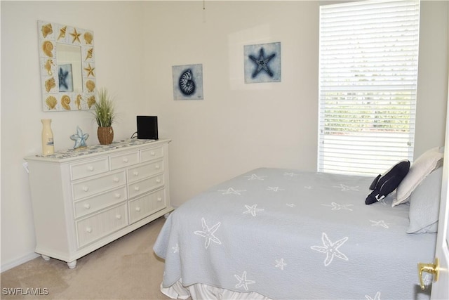 bedroom featuring light carpet