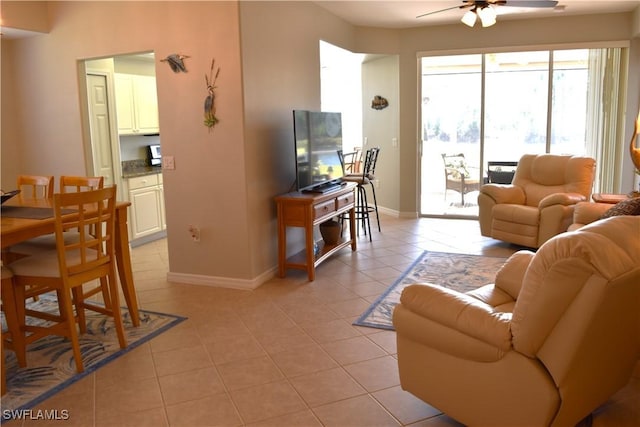 living room featuring ceiling fan and light tile patterned flooring