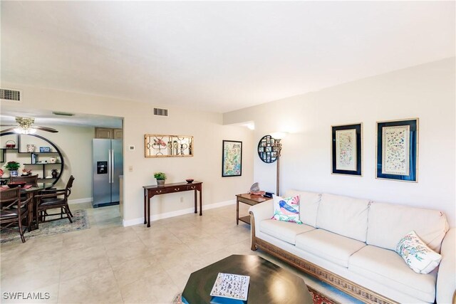 living room with ceiling fan and light tile patterned floors