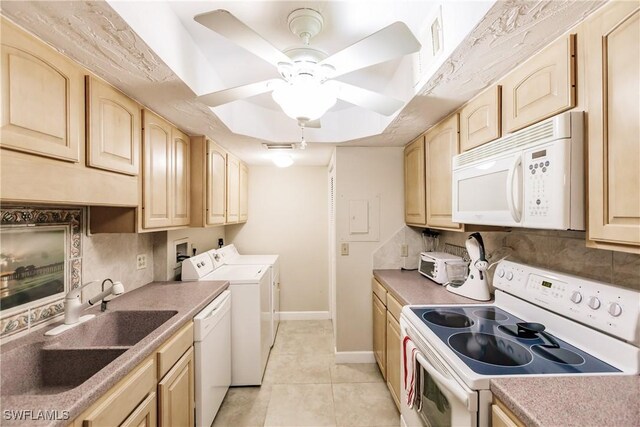 washroom with ceiling fan, separate washer and dryer, sink, and light tile patterned floors