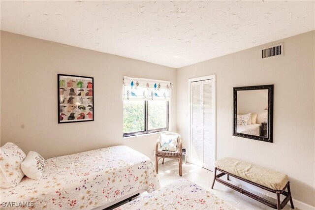 bedroom with a closet and a textured ceiling