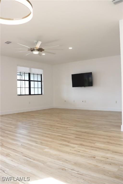 unfurnished living room with ceiling fan and light wood-type flooring