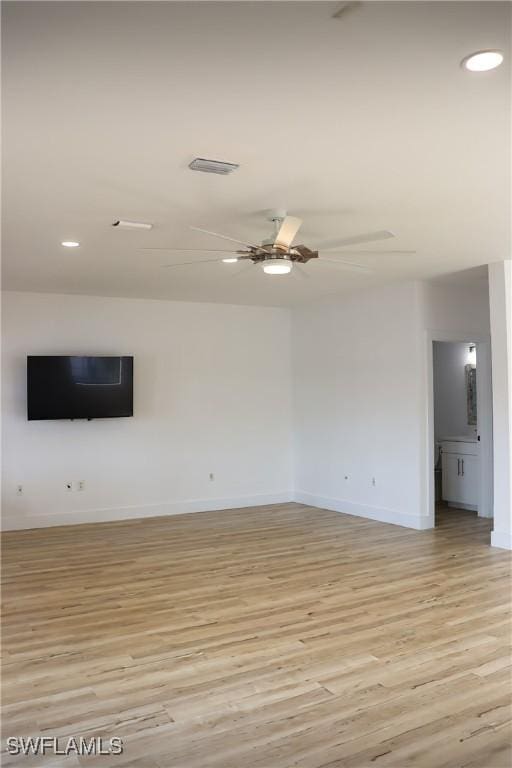 unfurnished living room with ceiling fan and light hardwood / wood-style floors