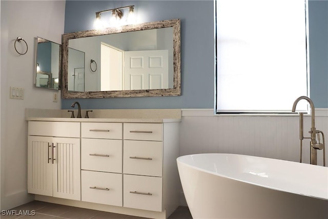 bathroom with vanity, tile patterned floors, and a tub