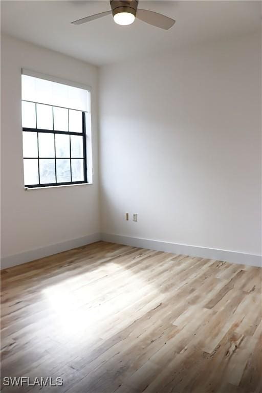 spare room with ceiling fan and light hardwood / wood-style flooring