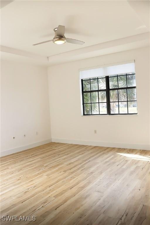 spare room featuring light hardwood / wood-style floors and ceiling fan