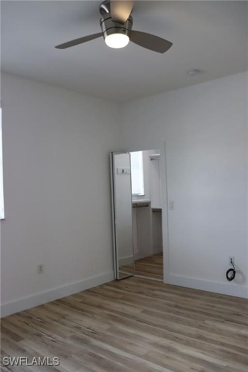 unfurnished bedroom with ceiling fan and light wood-type flooring