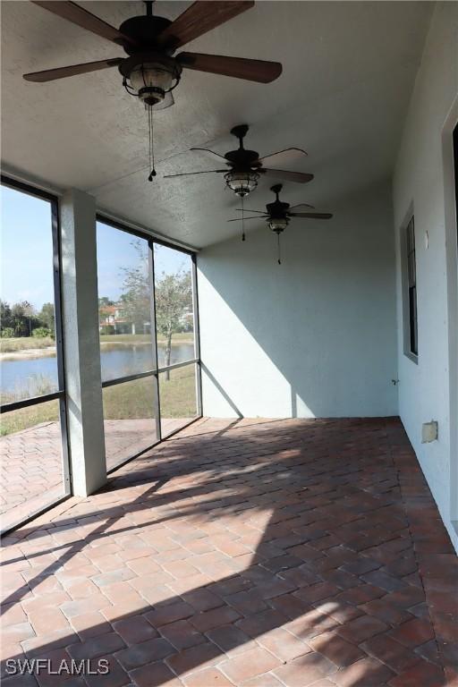 unfurnished sunroom with a water view and a wealth of natural light