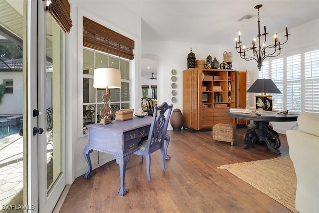 dining space with a notable chandelier and hardwood / wood-style flooring