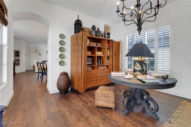 dining space featuring dark hardwood / wood-style flooring and an inviting chandelier