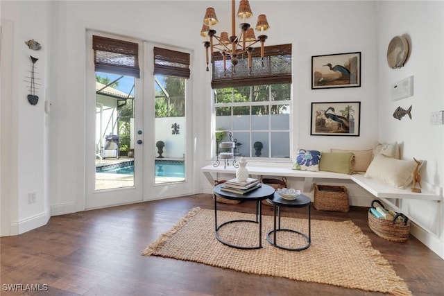 living area featuring dark wood-type flooring and a chandelier