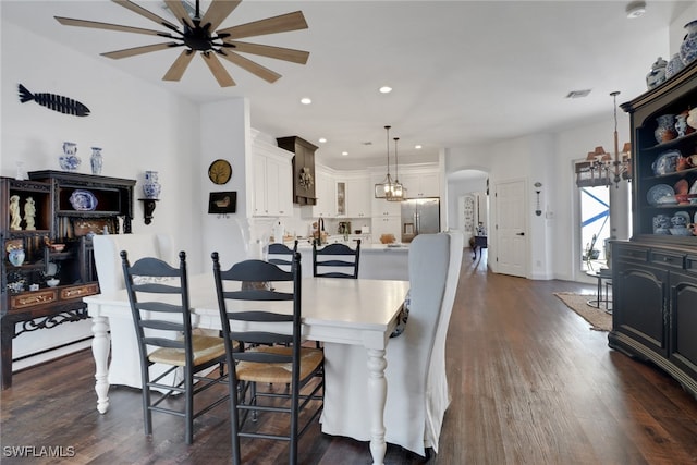 dining room featuring dark wood-type flooring and a notable chandelier