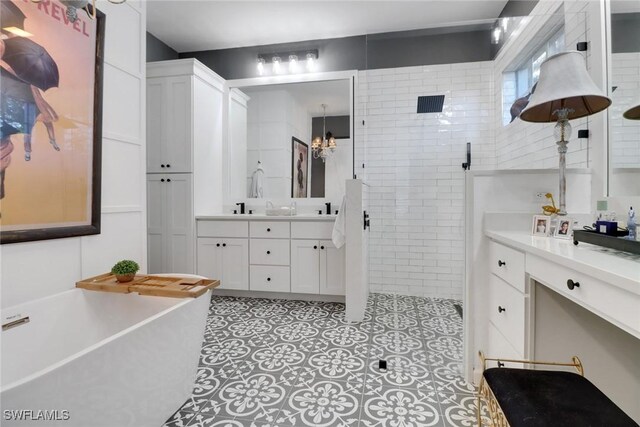 bathroom with independent shower and bath and vanity