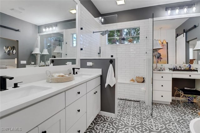 bathroom featuring vanity, tile patterned floors, and tiled shower