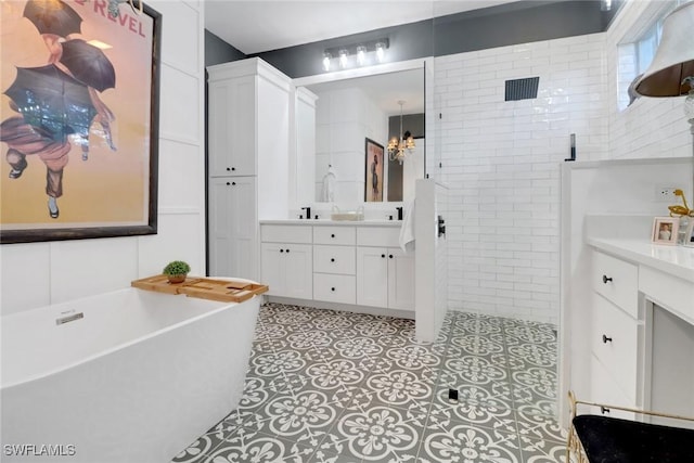 bathroom featuring vanity, tile patterned floors, and plus walk in shower