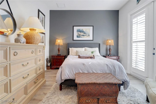 bedroom featuring light hardwood / wood-style floors and multiple windows