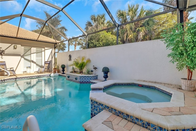 view of swimming pool featuring glass enclosure and an in ground hot tub