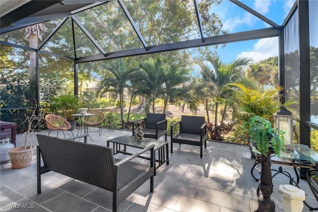 view of patio with an outdoor living space and glass enclosure