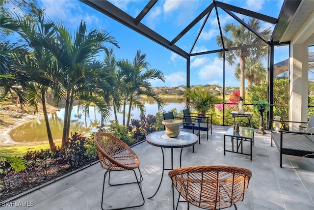 view of patio / terrace featuring a water view and a lanai