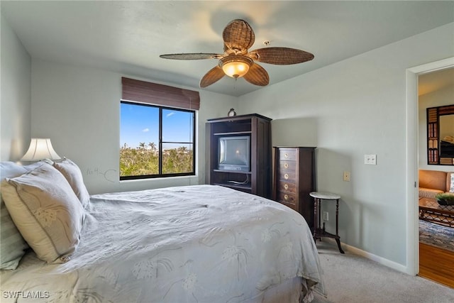 bedroom with light carpet and ceiling fan