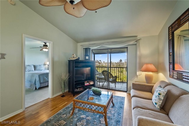 living room featuring wood-type flooring, lofted ceiling, and ceiling fan