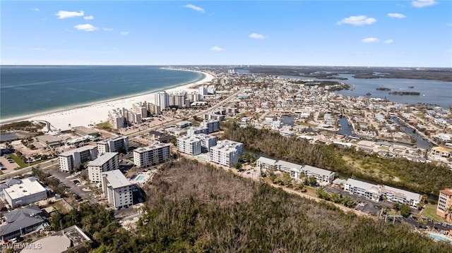 drone / aerial view with a water view and a beach view