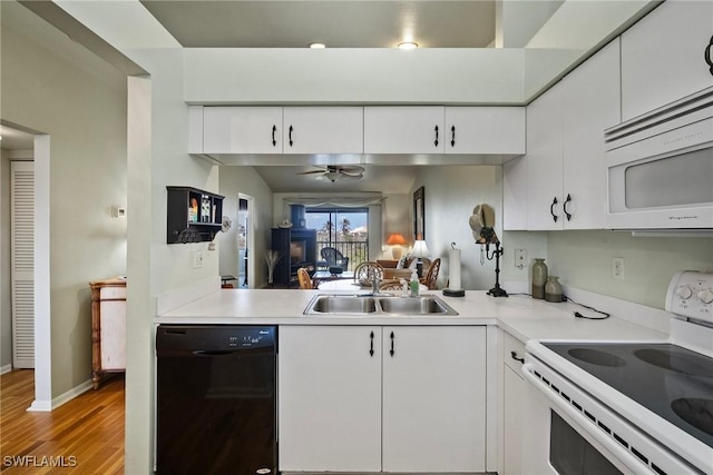 kitchen featuring sink, white appliances, ceiling fan, light hardwood / wood-style floors, and white cabinets