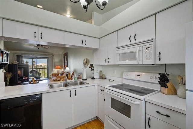 kitchen featuring white cabinetry, sink, ceiling fan, white appliances, and light hardwood / wood-style flooring