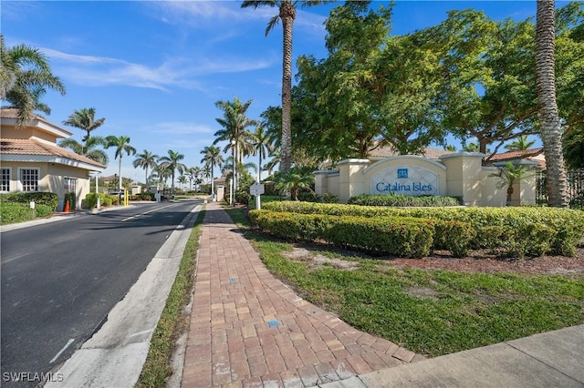 view of road with a gated entry and sidewalks