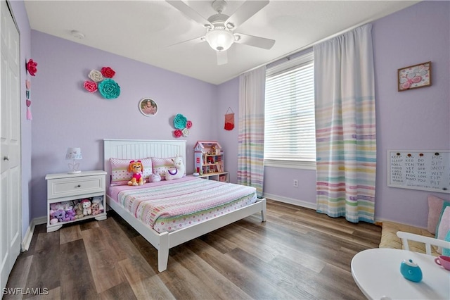 bedroom featuring multiple windows, baseboards, a ceiling fan, and wood finished floors