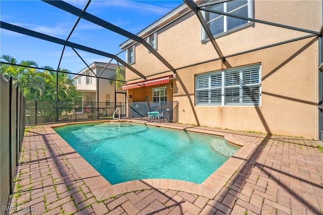view of pool with a patio, a fenced in pool, fence, and glass enclosure