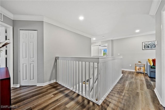 hall with wood-type flooring and crown molding