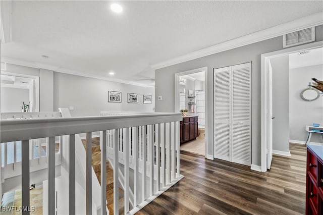hall featuring baseboards, recessed lighting, crown molding, dark wood-type flooring, and visible vents