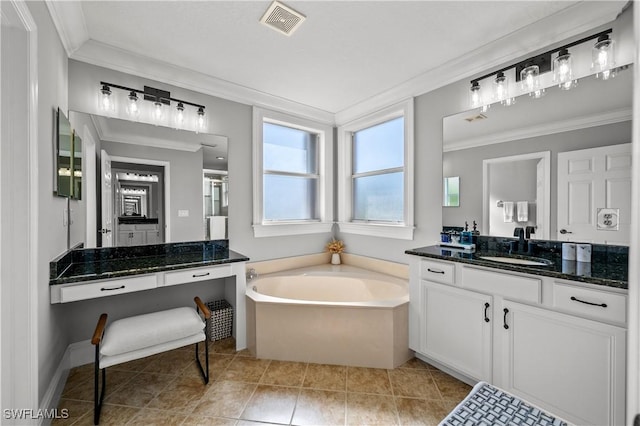 bathroom featuring vanity, crown molding, tile patterned floors, and a bathing tub