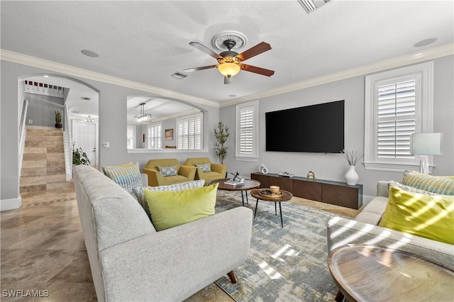 living area with arched walkways, ceiling fan, crown molding, and visible vents