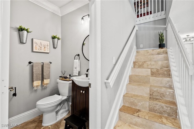 bathroom with vanity, crown molding, and toilet