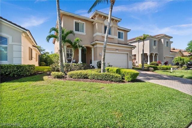 mediterranean / spanish home featuring driveway, a garage, stucco siding, and a front yard