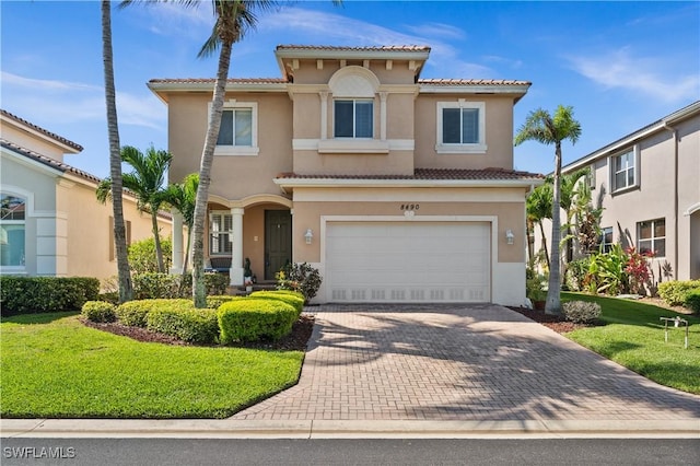 view of front of house featuring an attached garage, stucco siding, and decorative driveway